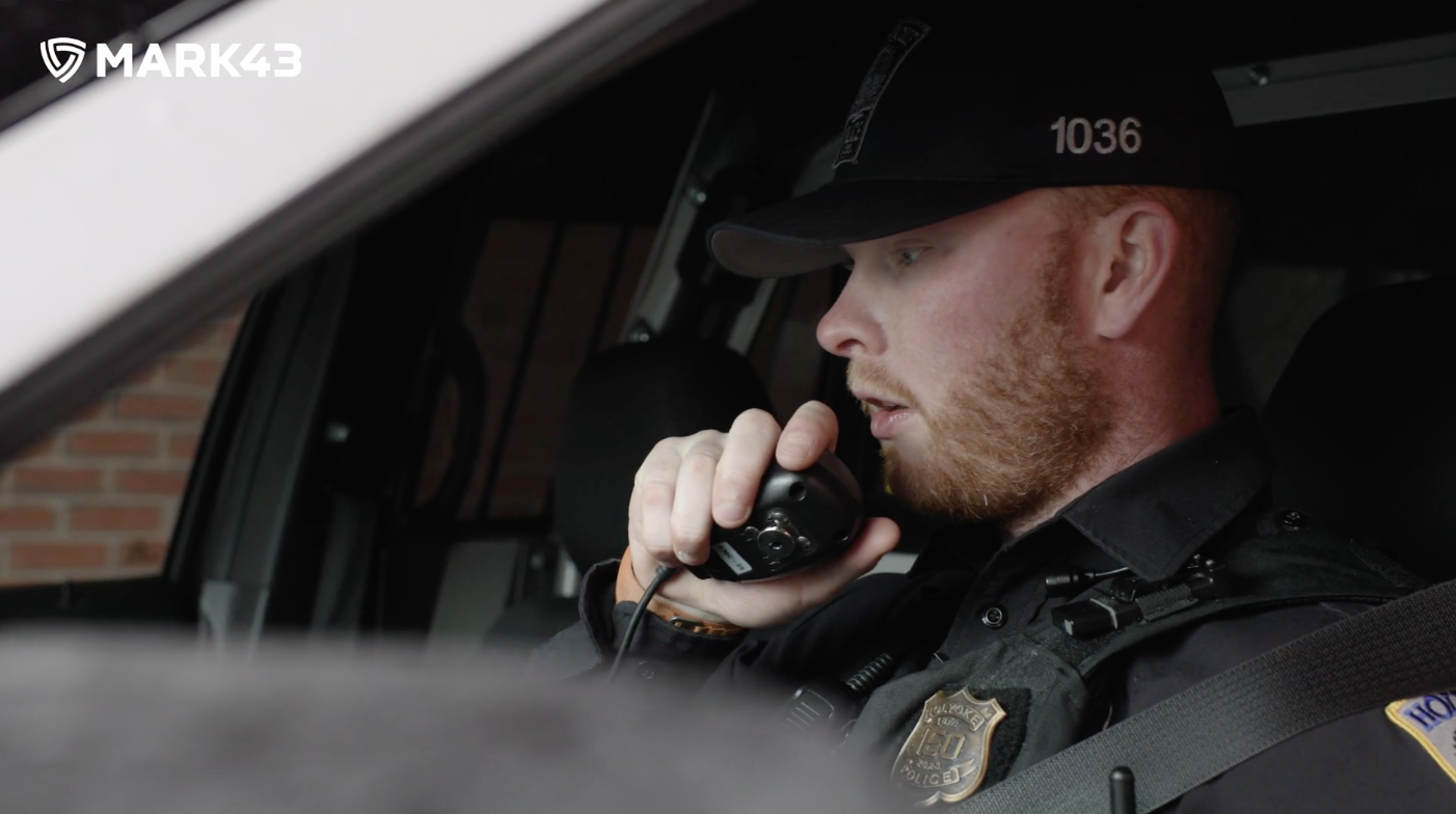 Police officer talking on the radio in their car